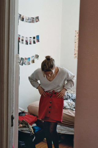 Woman Trying On Clothes in Bedroom