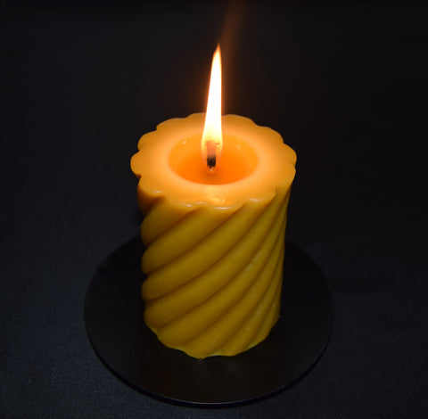 Beeswax pillar candle burning