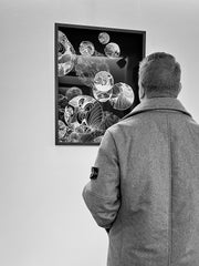 man admiring a painting of marie de decker on wall