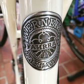 Tin label round on a headbadge of a bike