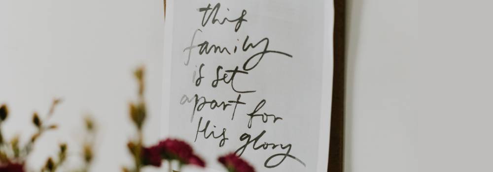 A Christian decal on a white wall with the words: This family is set apart for His glory.