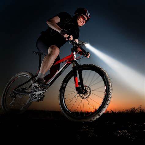 Man riding a bicycle with a bike light