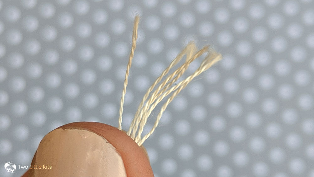 A close-up photo of 6-strand embroidery floss strands