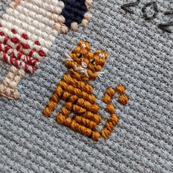 Cute little tabby cat in cross-stitch form