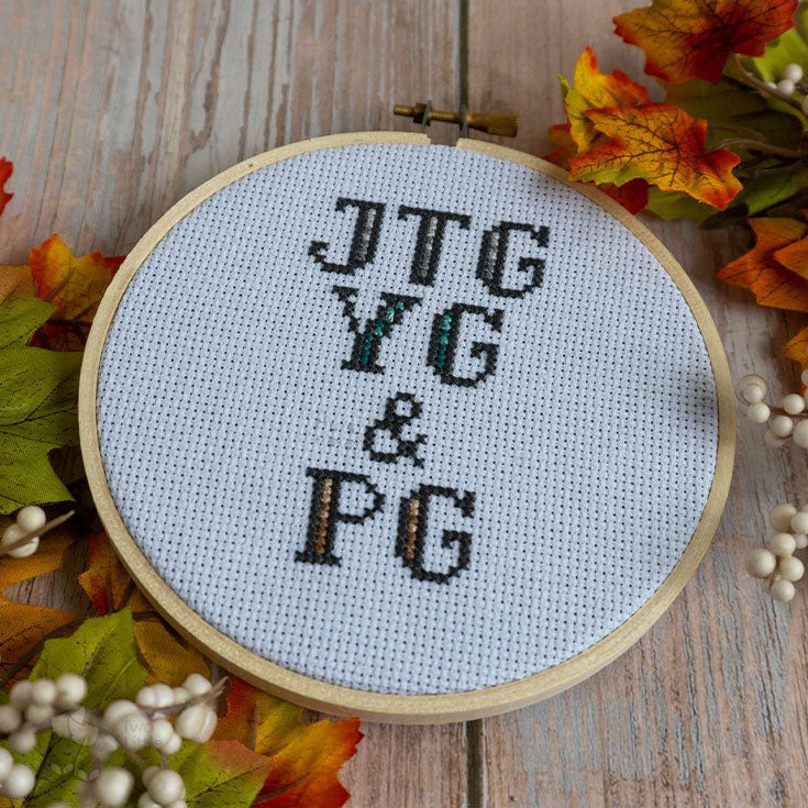 Three rows of initials in a 5in hoop. It reads from top to bottom: JTG, YG &amp; PG all done in cross-stitches.