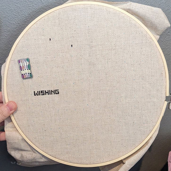 A large almost-blank cross-stitch piece that has barely been started.