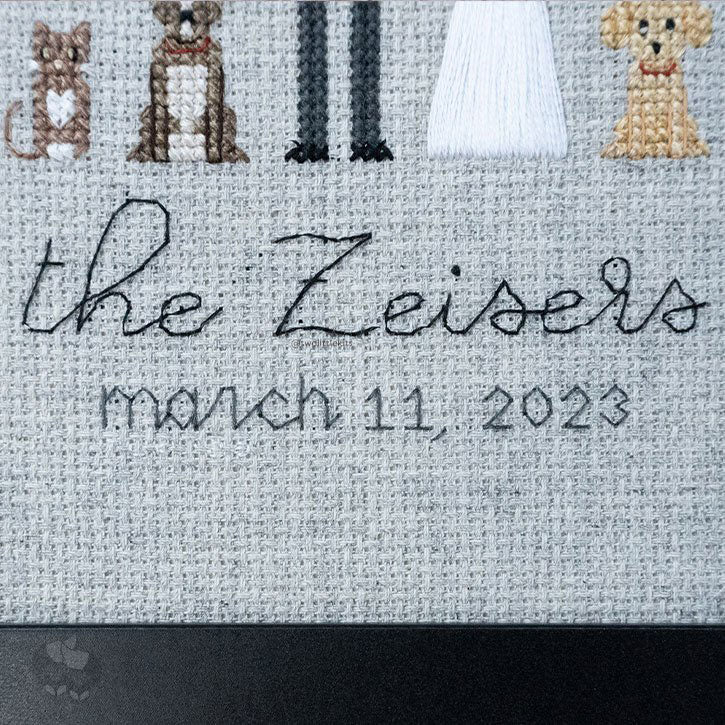 Close-up photo of the wording on the piece. The first line says "the Zeisers" and the second line says "march 11, 2023". Both are done with backstitching.