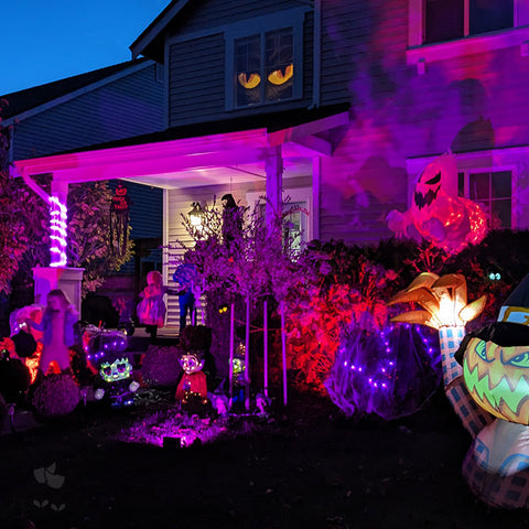 A highly-decorated home on Halloween evening.