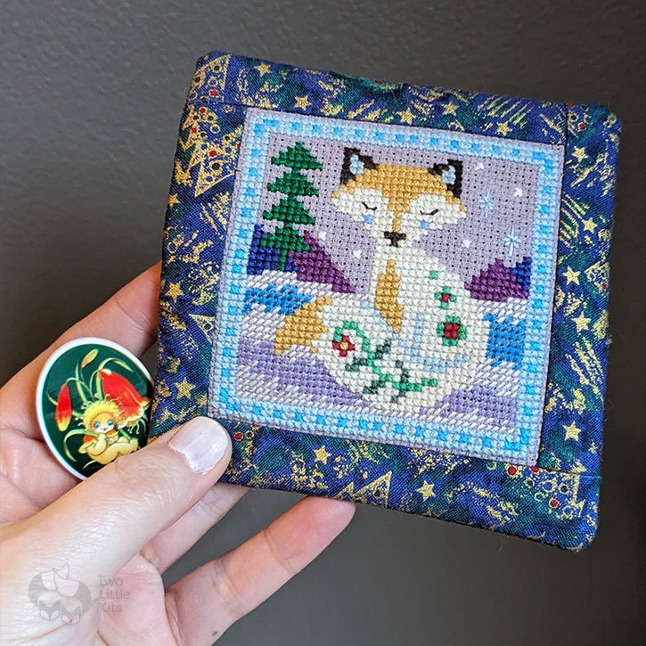 Gifts received at Christmas; a 'gumnut baby' needleminder and a cross-stitched fox