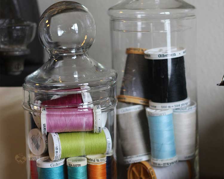 two clear glass jars with threads