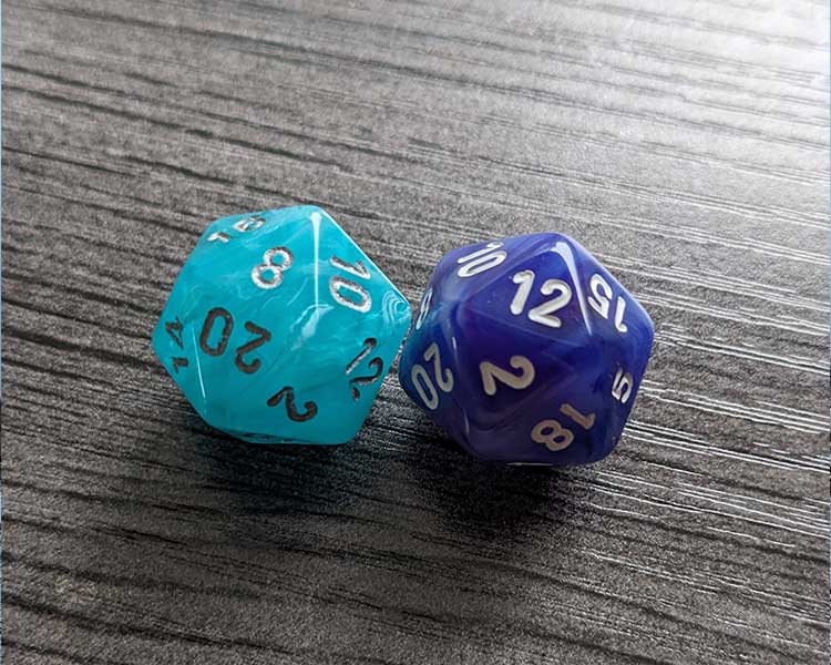 Two 20-sided dice. A teal-coloured one is showing an "8" and a purple one is showing a "12".