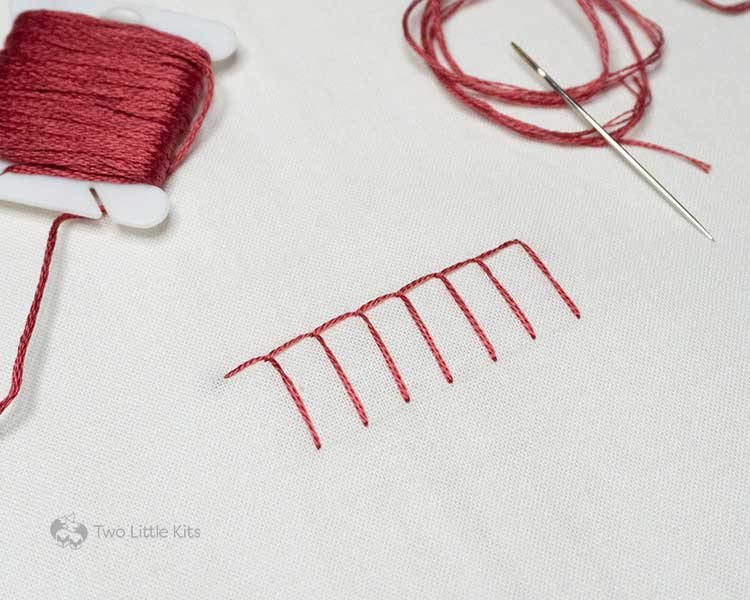 A red-coloured, hand embroidered basket stitch