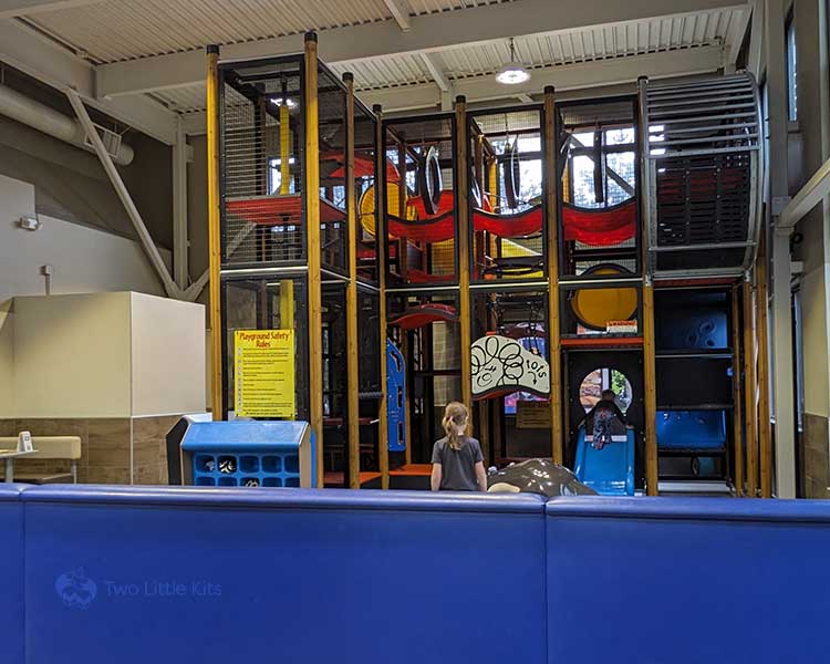 A few kids playing at an indoor playground that's inside a McDonald's location