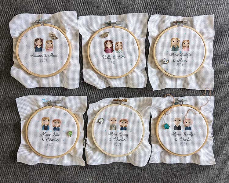 Six work-in-progress cross-stitch pieces of stitch people portraits (bust up only). Each piece includes two people