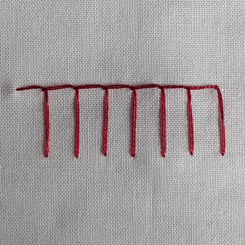 A red row of blanket stitches.️