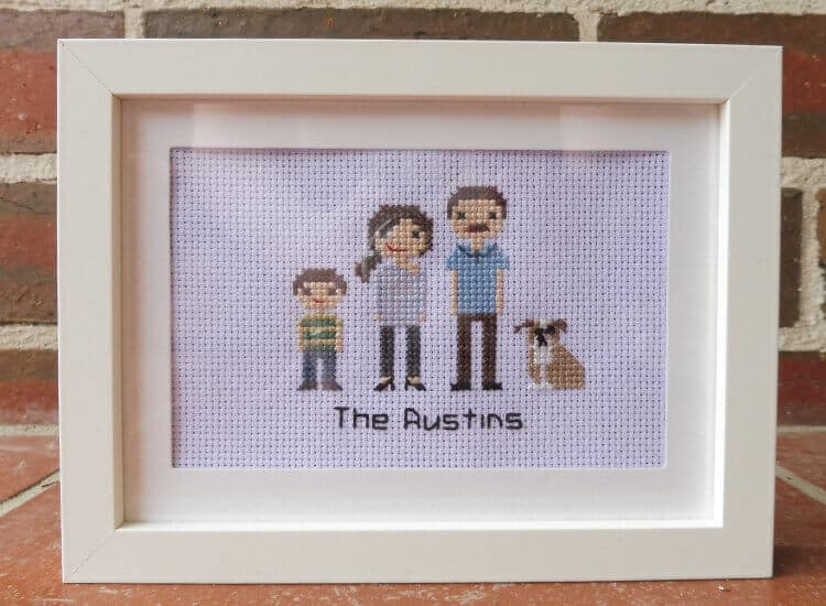 A cross-stitch portrait of a family of 4; mum, dad, son and dog.