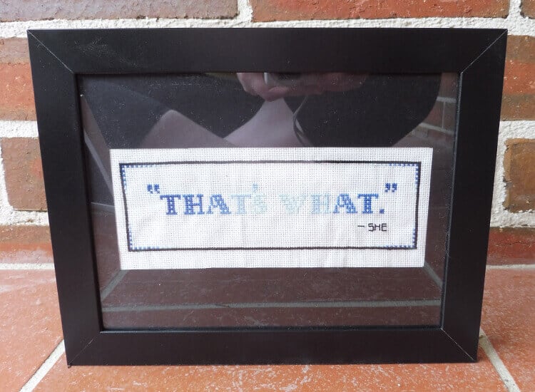 A framed cross-stitch