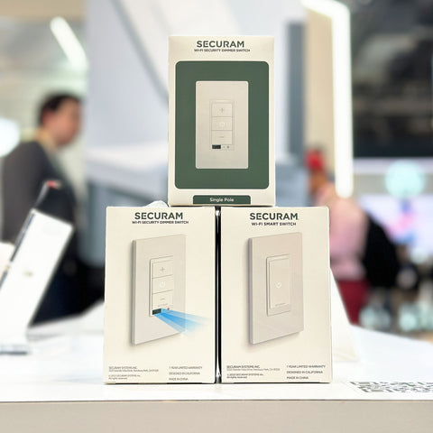 Foreground focuses on two SECURAM Wi-Fi Smart Switch packages prominently displayed, one labeled as a 'Single Pole' variant with an illustrative arrow showing an easy slide-in installation, and the other a standard package.