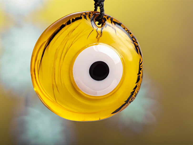 Close-up of a yellow evil eye talisman