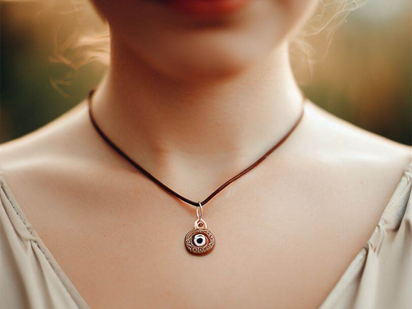 Person wearing a Brown Evil Eye necklace