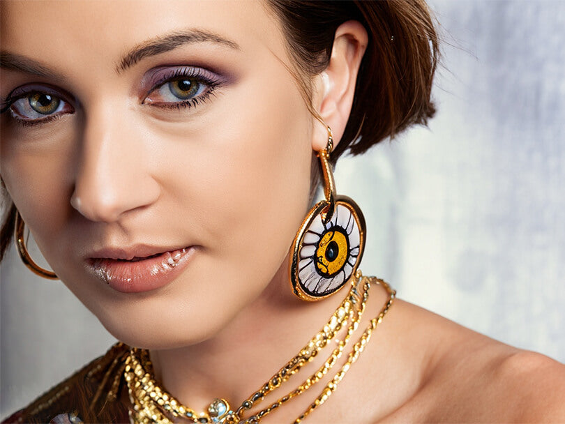 Woman wearing gold evil eye jewelry