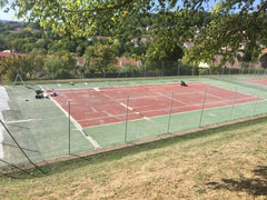 Modernisation et transformation d'un terrain de tennis en béton poreux vers une nouvelle surface, ou réparation pour une performance optimale.