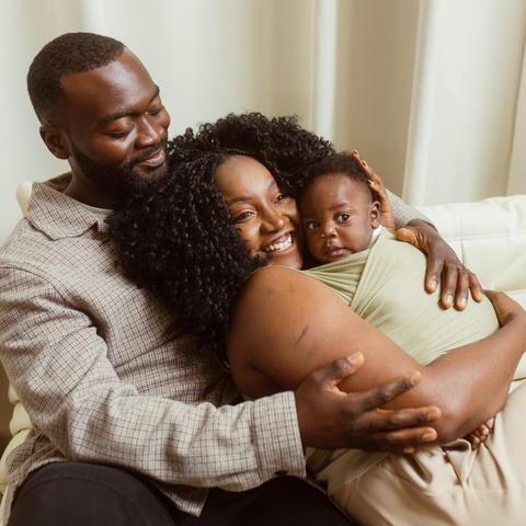 @sonish_space Sonia and her husband hold their newborn babe in a Chekoh Wrap