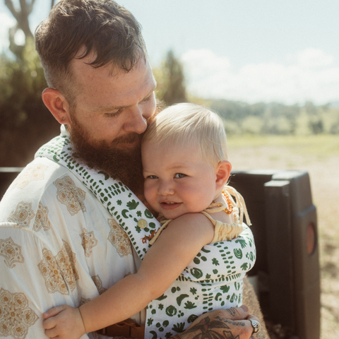 Dad Tim wears the Chekoh Baby Nevada Clip Carrier with baby Banksia