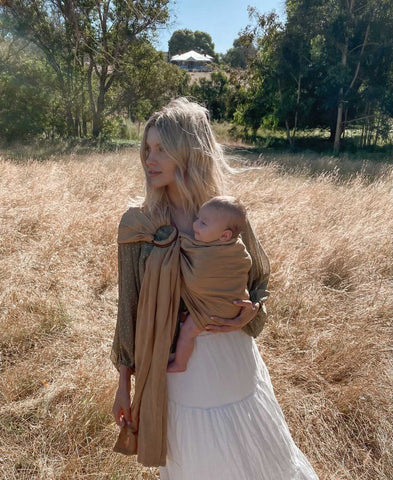 Mady Lee babywearing her daughter Indi in the Chekoh Ring Sling in Camel