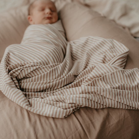 Snuggly baby all swaddled up in a Chekoh Baby Swaddle - perfect for newborns