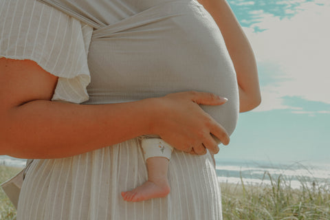 Beachside photography by @thesimpleimage wearing Chekoh Baby Carrier in Asha