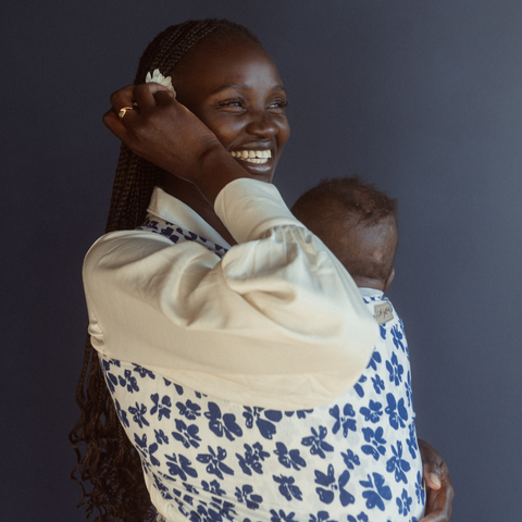 Nyamuoch wearing the new Des Fleurs stretchy baby wrap by Australian brand Chekoh