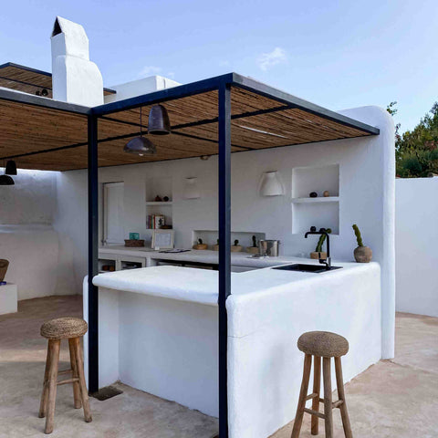 Open kitchen in the backyard with minimalist white and black color scheme