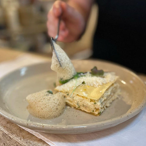 Chef spoons food onto Lil Ceramic plate