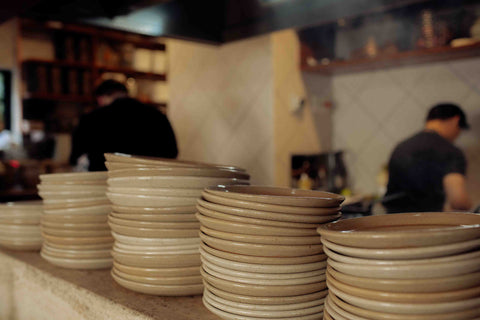 Stacks of Lil Ceramics plates on the counter of Ortolana, Britomart