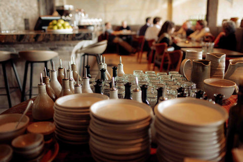 Amano, Britomart, table of oil pourers, plates by Lil Ceramics