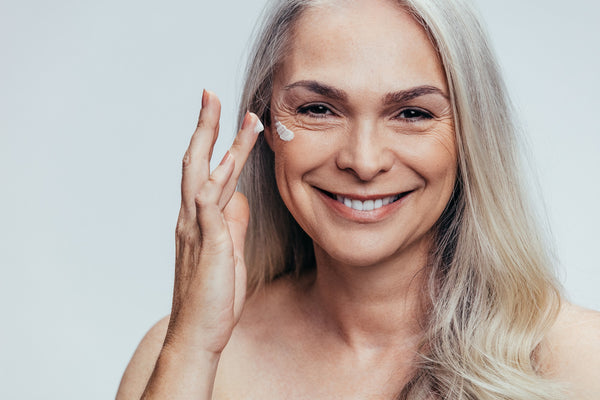 mature woman doing skincare