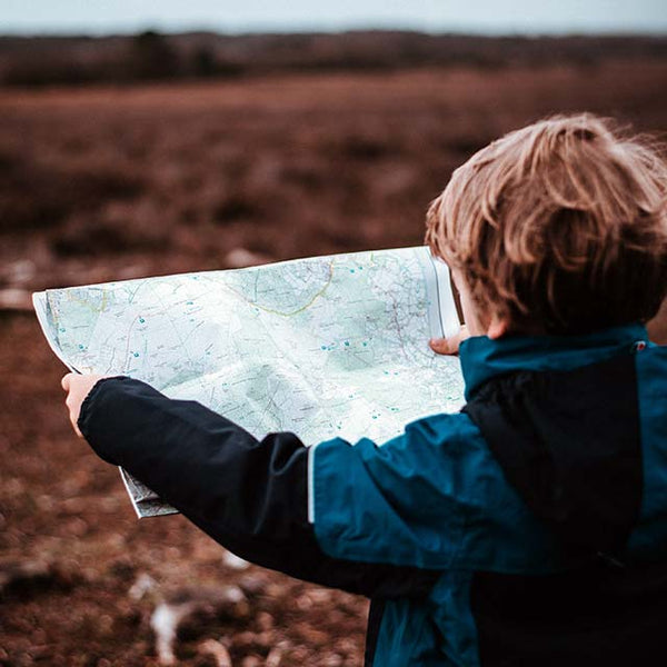 Boy holding map by Annie Sprat