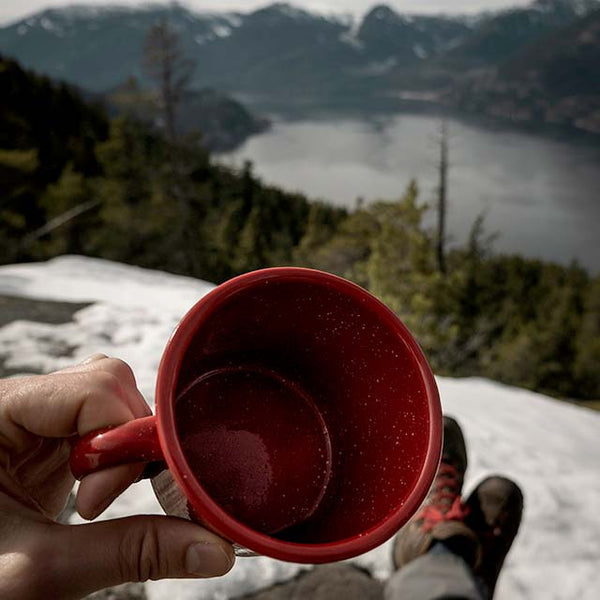Empty red mug on a snowy mountain by Yann Allegre