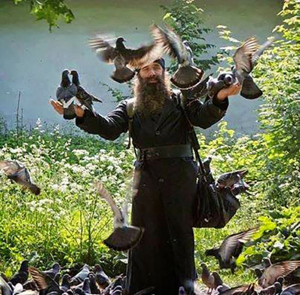 An Orthodox monk surrounded by pigeons