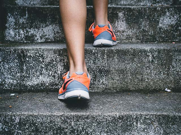 Running shoes up steps by Bruno Nasciment