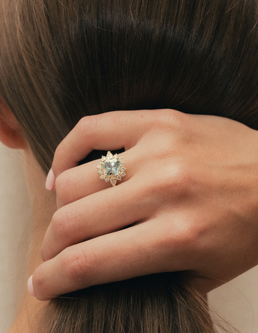 Bride wearing an aquamarine and diamond ring