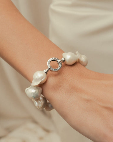 Bride wearing a baroque pearl bracelet with white gold clasp
