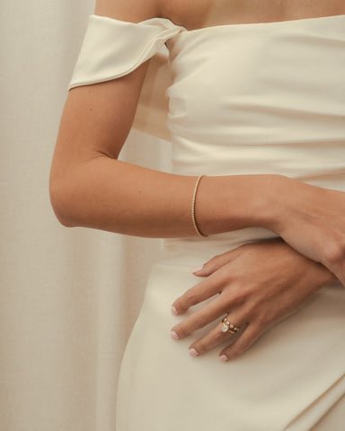 Bride wearing diamond tennis bracelet in strapless white gown