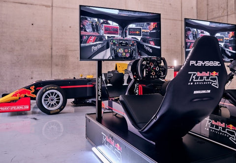 Image of the Playseat F1 Redbull Edition in front of a Redbull F1 Car
