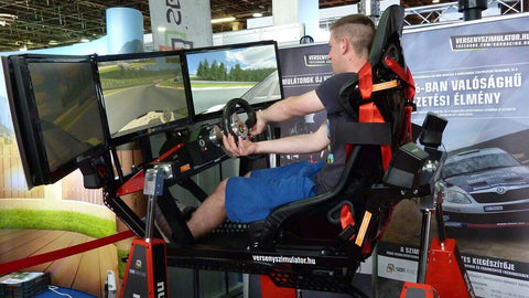 Man competing in a motion sim racing rig