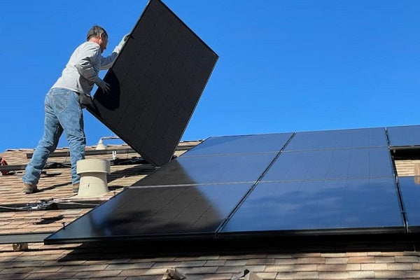 man-installing-solar-panels-under-sun