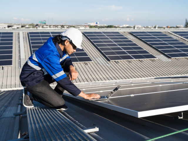 technician-working-on-solar-panels