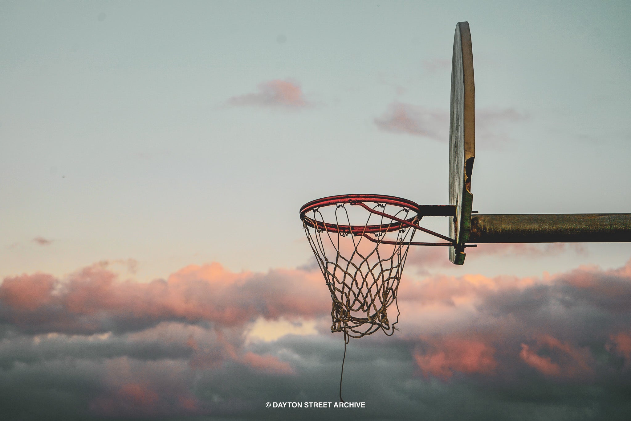 vintage basketball hoop with pink sky in background