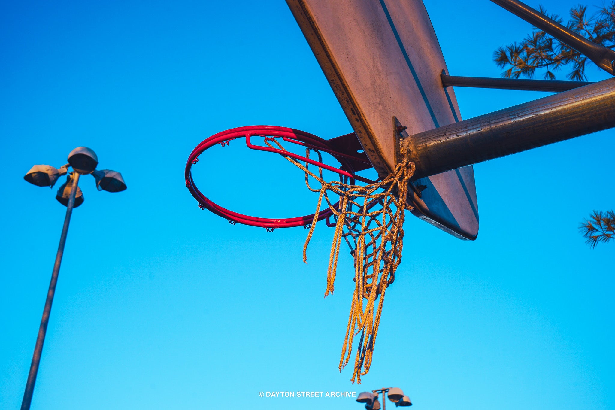 vintage summer basketball hoop with vibrant blue sky